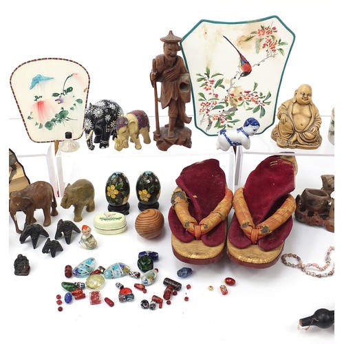 2084 - Chinese objects including reverse glass painted snuff bottles, lacquered shoes, carved wood stands, ... 