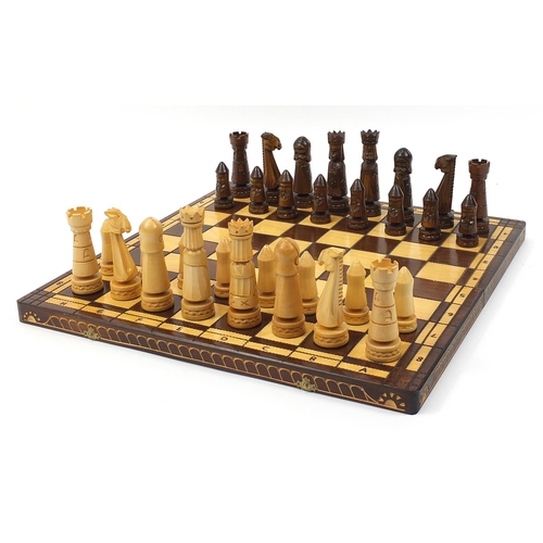 2061 - Large carved wood chess set with folding board, the largest pieces each 14cm high, the board 60cm x ... 