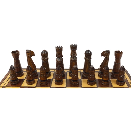 2061 - Large carved wood chess set with folding board, the largest pieces each 14cm high, the board 60cm x ... 