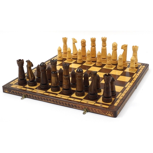 2061 - Large carved wood chess set with folding board, the largest pieces each 14cm high, the board 60cm x ... 