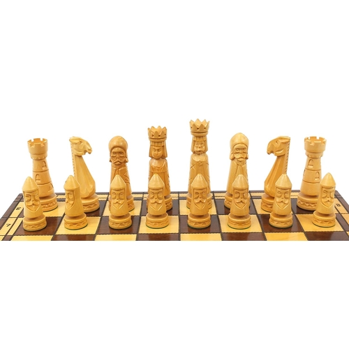 2061 - Large carved wood chess set with folding board, the largest pieces each 14cm high, the board 60cm x ... 