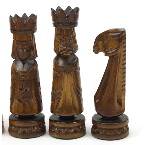 2061 - Large carved wood chess set with folding board, the largest pieces each 14cm high, the board 60cm x ... 