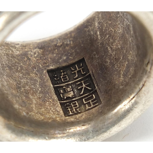 1958 - Chinese silver coloured metal archer's ring with rotating band, size Z