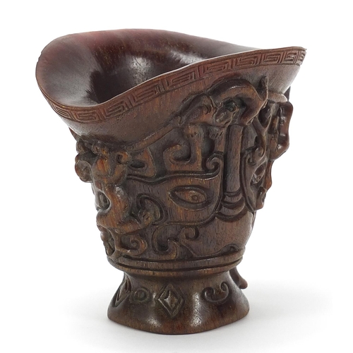 2033 - Chinese libation cup carved with dogs of Foo, four figure character marks to the base, 13.5cm high