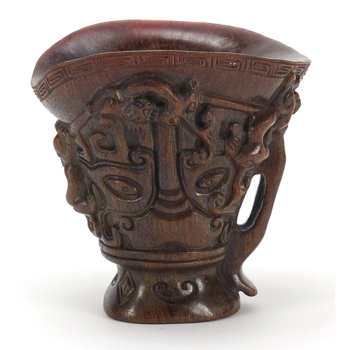 2033 - Chinese libation cup carved with dogs of Foo, four figure character marks to the base, 13.5cm high