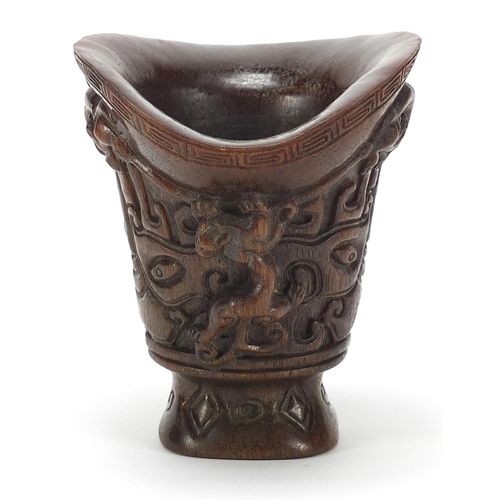 2033 - Chinese libation cup carved with dogs of Foo, four figure character marks to the base, 13.5cm high