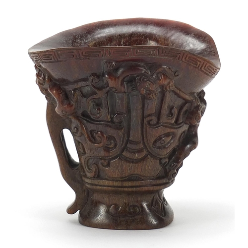 2033 - Chinese libation cup carved with dogs of Foo, four figure character marks to the base, 13.5cm high