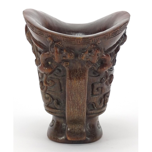 2033 - Chinese libation cup carved with dogs of Foo, four figure character marks to the base, 13.5cm high