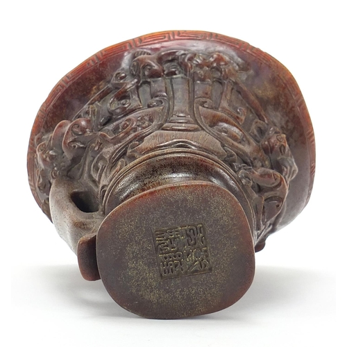 2033 - Chinese libation cup carved with dogs of Foo, four figure character marks to the base, 13.5cm high