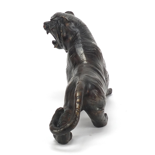 653 - Large Japanese patinated bronze tiger, 31cm in length