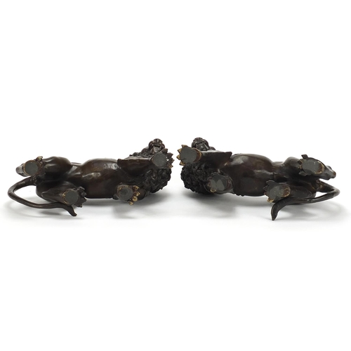 345A - Large pair of Grand Tour style patinated bronze lions, 30cm in length