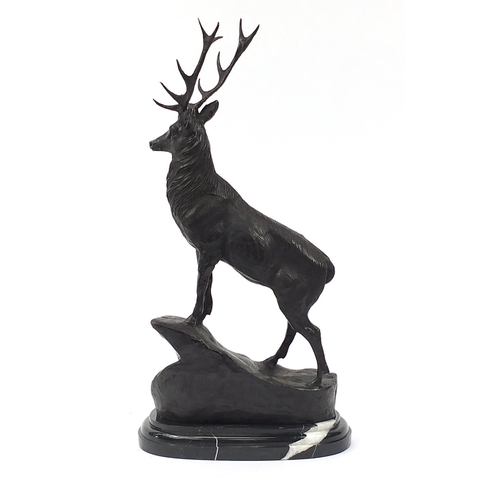 840 - Large patinated bronze stag raised on a shaped marble base, 74cm high