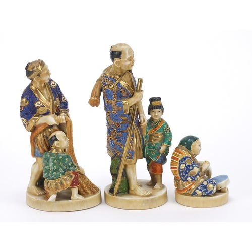 652 - Three Japanese Satsuma pottery figures including two of a father with child, the largest 18.5cm high