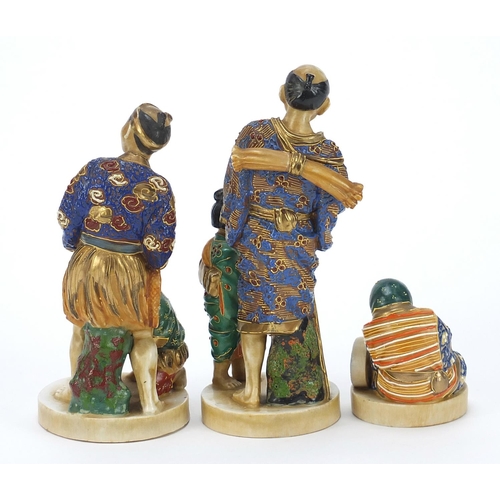 652 - Three Japanese Satsuma pottery figures including two of a father with child, the largest 18.5cm high