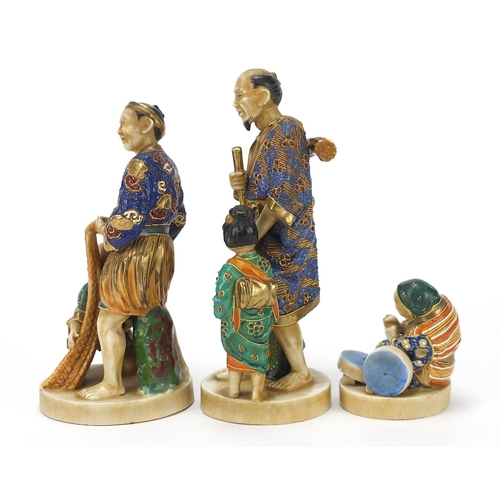 652 - Three Japanese Satsuma pottery figures including two of a father with child, the largest 18.5cm high