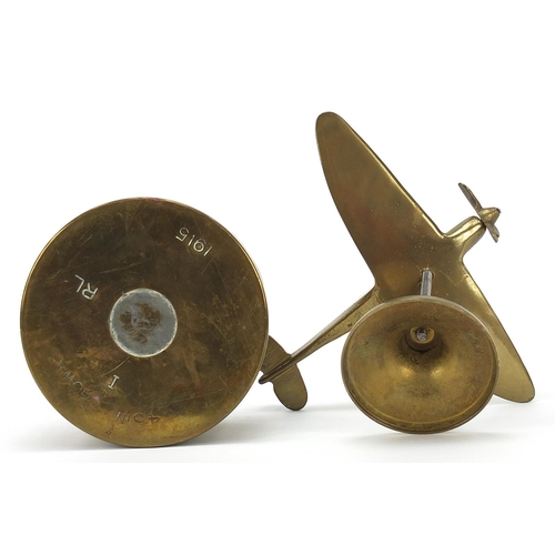 1955 - Military interest brass Spitfire and a trench art shell, the largest 20cm wide