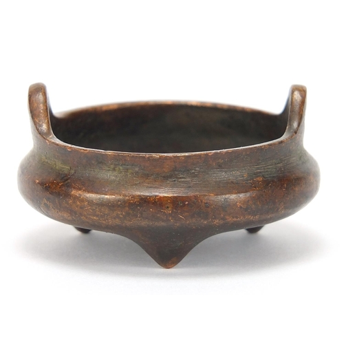 2043 - Chinese patinated bronze tripod censer with twin handles, character marks to the base, 5.5cm in diam... 