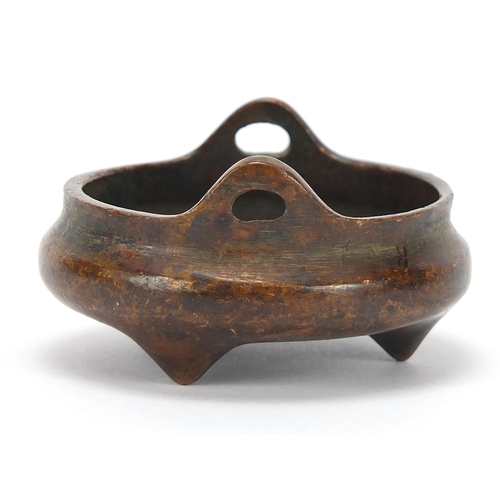 2043 - Chinese patinated bronze tripod censer with twin handles, character marks to the base, 5.5cm in diam... 