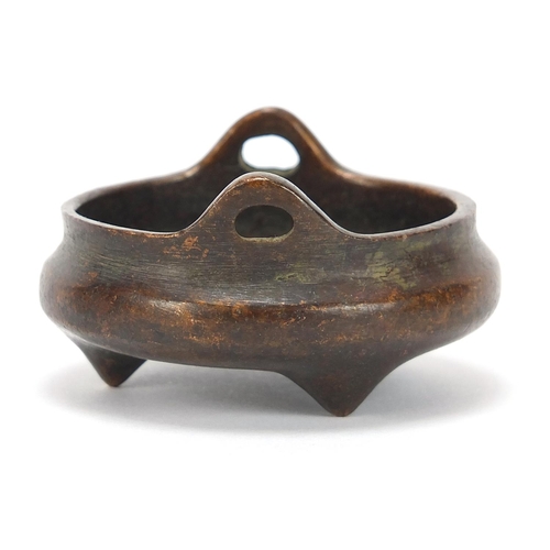 2043 - Chinese patinated bronze tripod censer with twin handles, character marks to the base, 5.5cm in diam... 