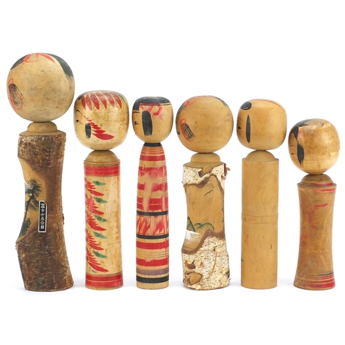 765 - Six Japanese Kokeshi hand painted wood dolls, the largest 29cm high