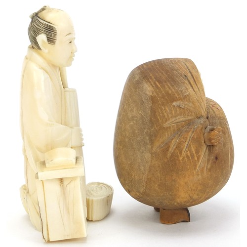 170 - Two Japanese okimonos including a carved ivory example of a man holding a parasol, the largest 7.5cm... 