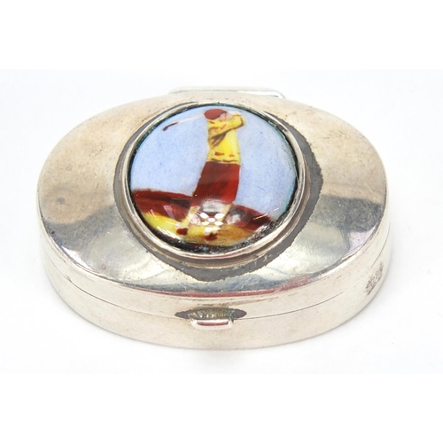 793 - Oval sterling silver pill box, the hinged lid enamelled with a  female golfer, 3.2cm wide, 11.5g