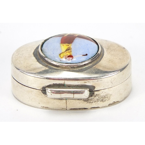 793 - Oval sterling silver pill box, the hinged lid enamelled with a  female golfer, 3.2cm wide, 11.5g