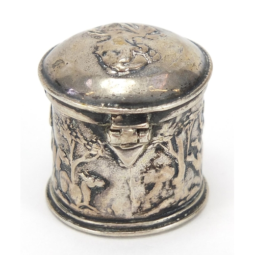 486 - Antique silver cylindrical box with hinged lid embossed with mythical figures, indistinct marks to t... 