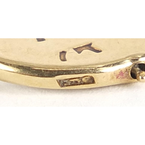 114 - 9ct gold 'Good Luck' spinner charm, 1.8cm high, 1.1g