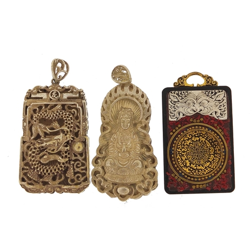 1830 - Two Chinese silver coloured metal pendants and one other, the largest 6.5cm high