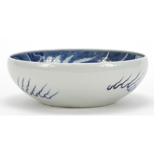 442 - Chinese blue and white porcelain bowl hand painted with a dragon amongst clouds above waves, blue ri... 