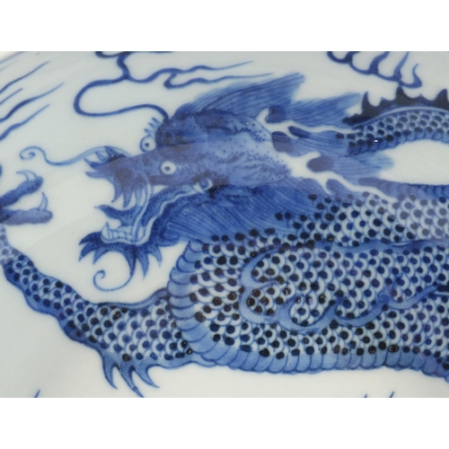 442 - Chinese blue and white porcelain bowl hand painted with a dragon amongst clouds above waves, blue ri... 