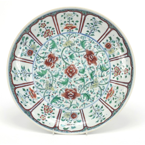 23 - Chinese doucai porcelain plate finely hand painted with flowers amongst scrolling foliage, six figur... 