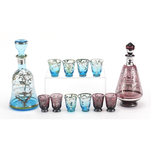 2006 - Vintage silver overlaid glass liqueur sets comprising two decanters and ten glasses, the largest dec... 