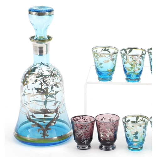 2006 - Vintage silver overlaid glass liqueur sets comprising two decanters and ten glasses, the largest dec... 