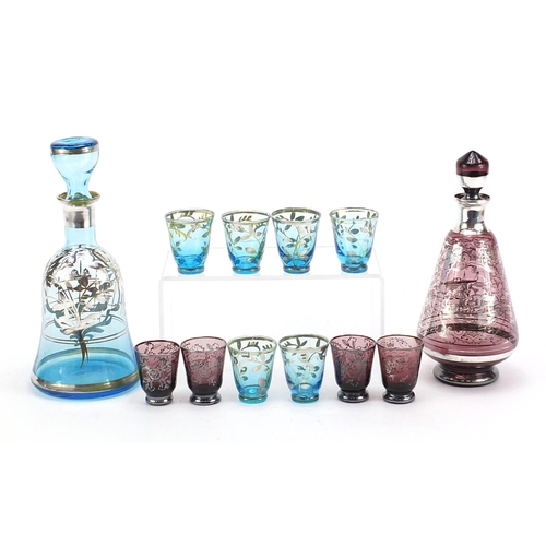 2006 - Vintage silver overlaid glass liqueur sets comprising two decanters and ten glasses, the largest dec... 