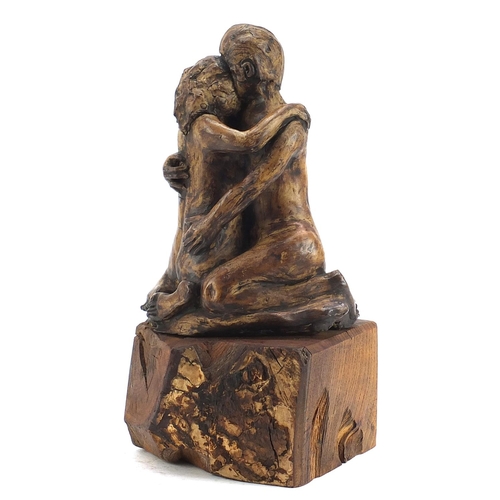 1787 - Modernist sculpture of two lovers raised on a naturalistic wood block base, 35cm high