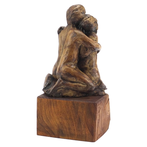 1787 - Modernist sculpture of two lovers raised on a naturalistic wood block base, 35cm high