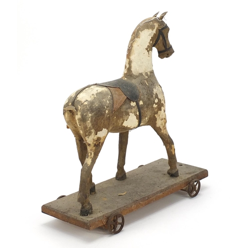 844 - Antique wooden pull along horse, 32.5cm in length