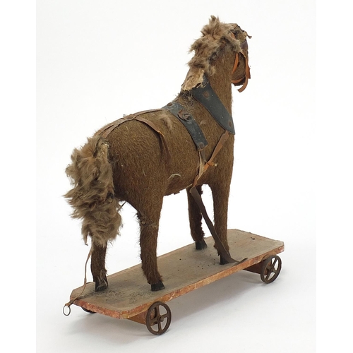 845 - Antique wooden pull along horse, 29cm in length