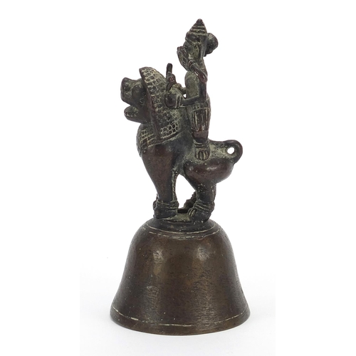 1805 - Indian bronze bell in the form of a deity on mythical animal, 12cm high