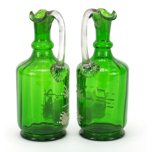 416 - Pair of Victorian Mary Gregory green glass claret jugs, each 24cm high