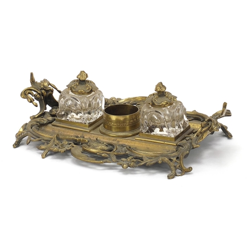 1801 - 19th century ornate brass desk stand with two glass inkwells, 32cm wide