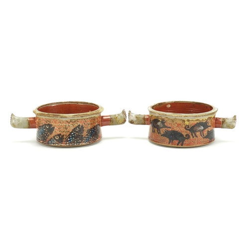 195 - Pair of studio pottery twin handled bowls hand painted with hogs and fish, painted marks to the base... 