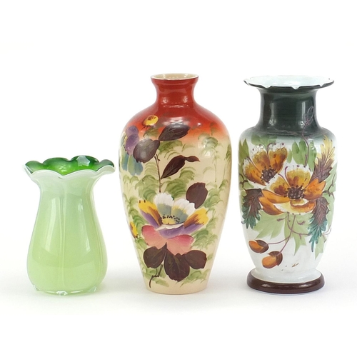 1834 - Two Victorian hand painted opaline glass vases and one other, the largest 26.5cm high