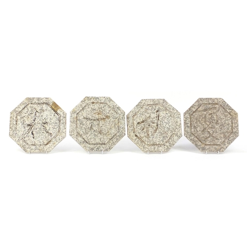 2579 - Four octagonal hardstone plaques carved with Chinese calligraphy, each 30cm in diameter