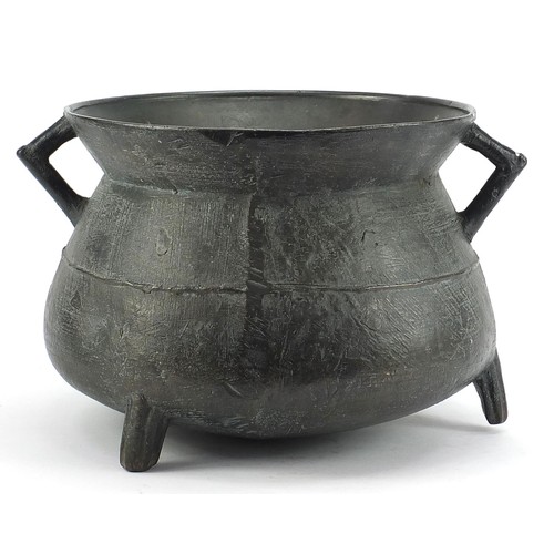 601 - 17th century patinated bronze cauldron, 23cm high x  35cm in diameter including the handles