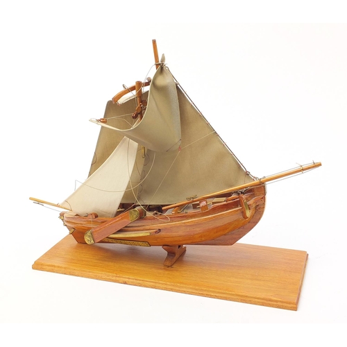 1018 - Large wooden model boat with canvas sails raised on a plinth base, 58cm in length