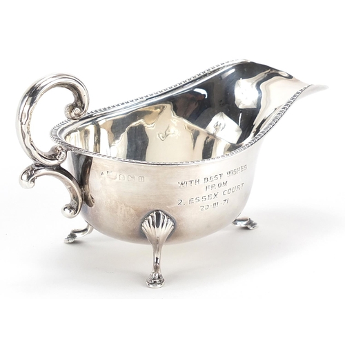 85 - Silver sauce boat raised on three hoof feet, Birmingham, 1932, 15cm in length, 99.2g