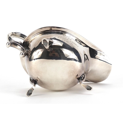 85 - Silver sauce boat raised on three hoof feet, Birmingham, 1932, 15cm in length, 99.2g